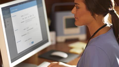 A clinician checking data on a screen